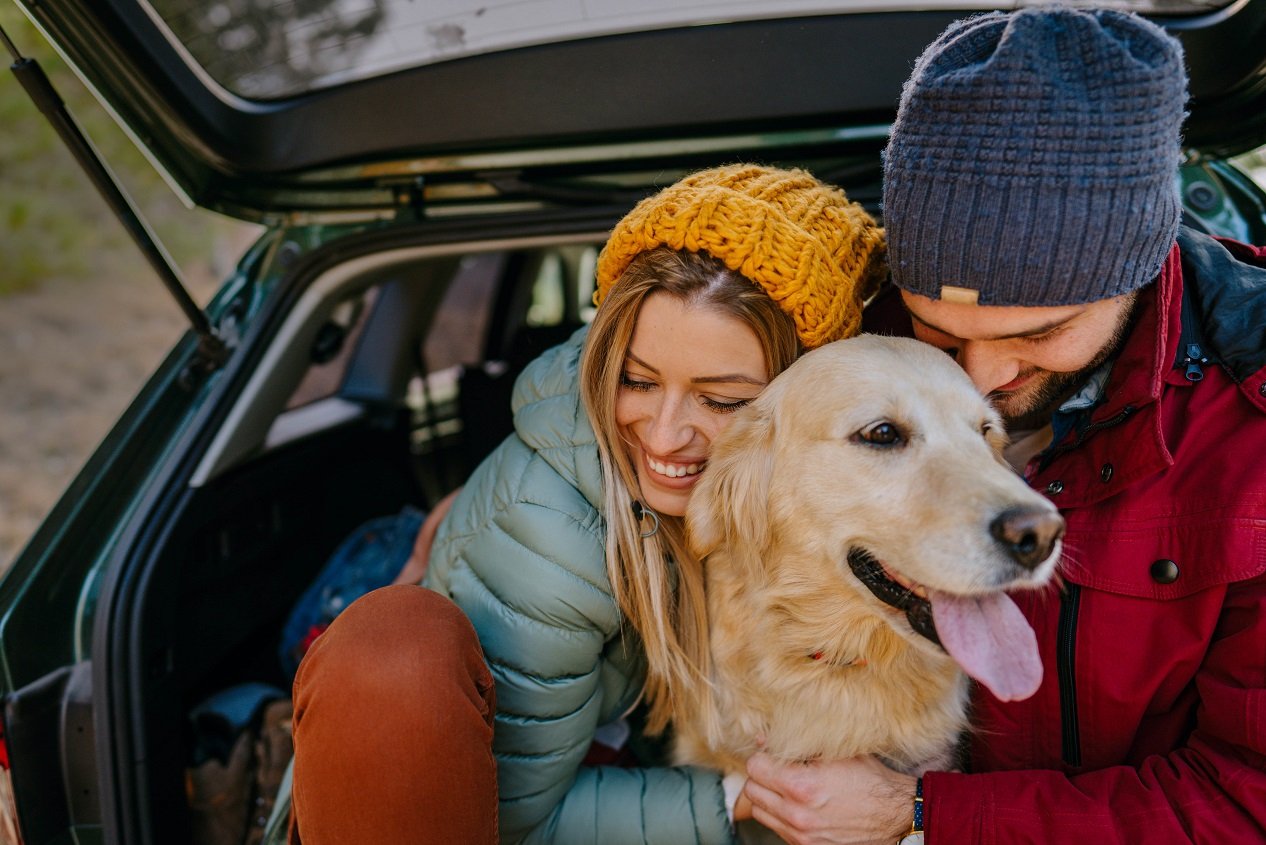 people hugging a dog